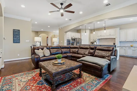 a living room with furniture and a wooden floor