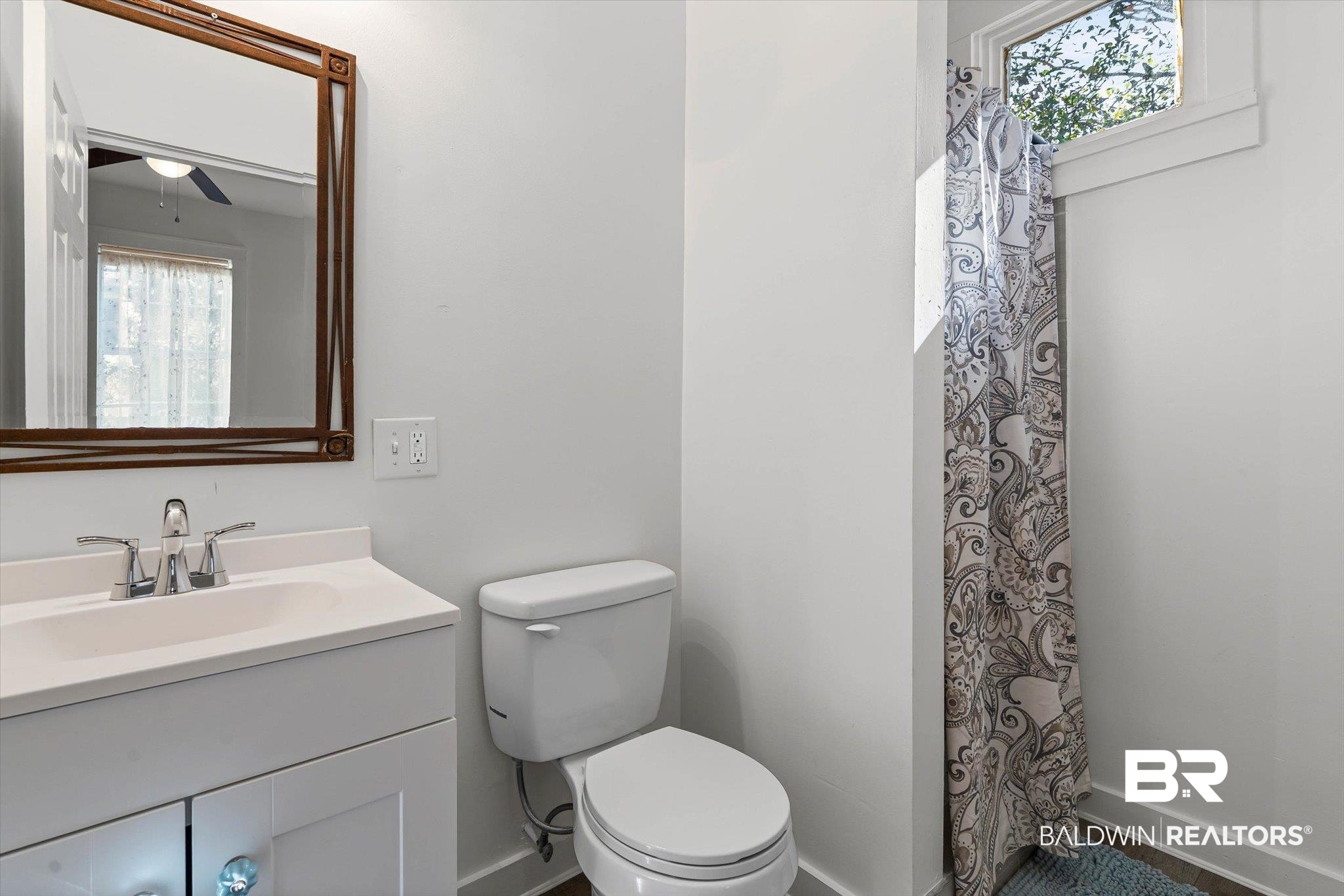 951 Montgomery Street Mobile, AL 36604 - Photo 13 of 22 Bathroom featuring a white vanity with integrated sink, chrome faucet, and a toilet