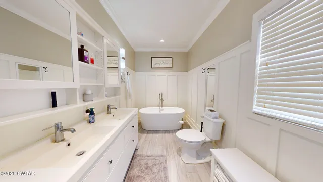 a bathroom with a double vanity sink mirror and toilet