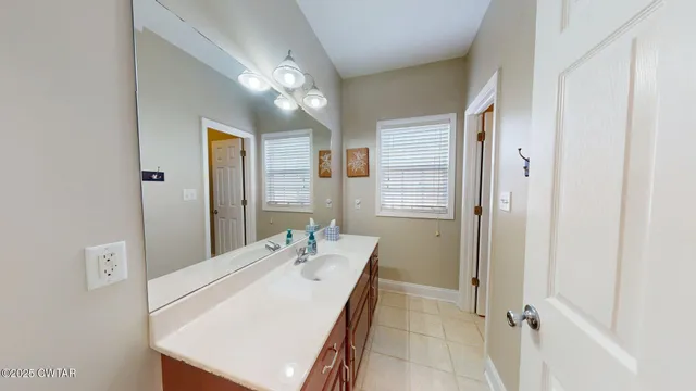 a bathroom with a double vanity sink a mirror and a shower