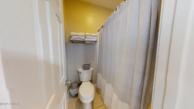a white toilet sitting next to a small bathroom