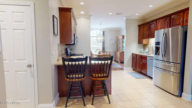 a kitchen with stainless steel appliances granite countertop a refrigerator and a stove top oven