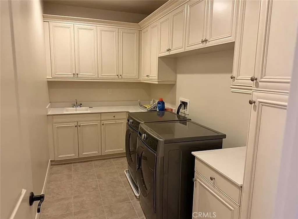 10 Hawkeye Irvine, CA 92602 - Photo 11 of 13 a utility room with sink dryer and washer