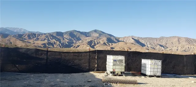a front view of a house with mountain view