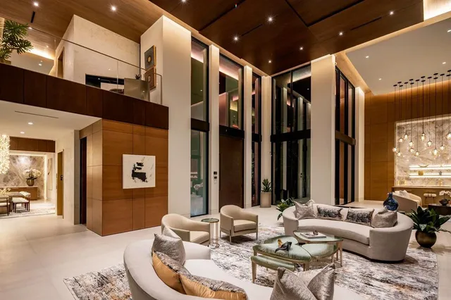 a spacious bedroom with a large bed and a chandelier