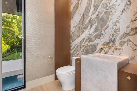 a aerial view of a house with a garden and lake view