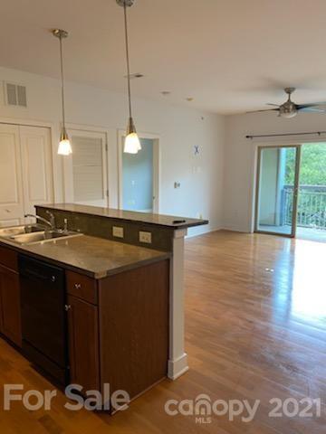 630 Calvert Street, Unit 409 Charlotte, NC 28208 - Photo 3 of 11 a bathroom with a sink a mirror and window