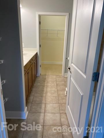 630 Calvert Street, Unit 409 Charlotte, NC 28208 - Photo 6 of 11 a bathroom with a granite countertop shower and a sink