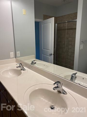 630 Calvert Street, Unit 409 Charlotte, NC 28208 - Photo 7 of 11 a bathroom with a sink and a mirror