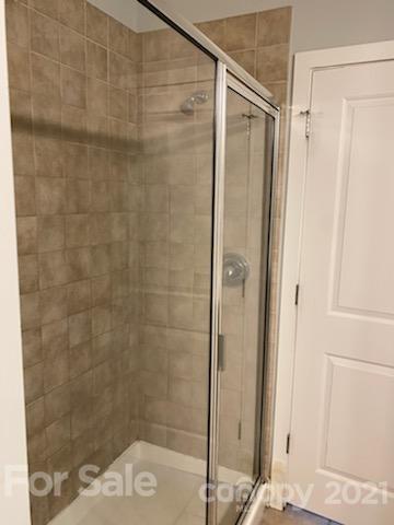 630 Calvert Street, Unit 409 Charlotte, NC 28208 - Photo 8 of 11 a bathroom with a glass shower door