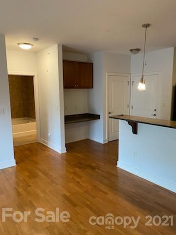 630 Calvert Street, Unit 409 Charlotte, NC 28208 - Photo 9 of 11 a view of a kitchen with a sink and cabinets