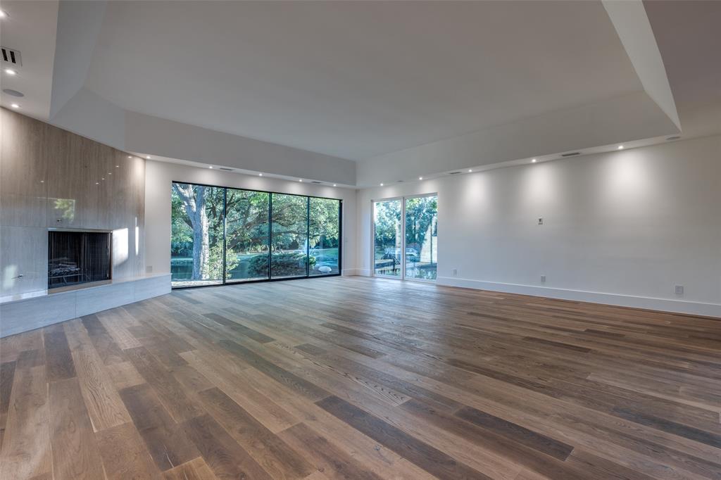 12002 Timberlake Court Dallas, TX 75230 - Photo 11 of 28 a view of an empty room with wooden floor and a window