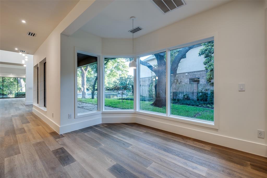 12002 Timberlake Court Dallas, TX 75230 - Photo 12 of 28 an empty room with wooden floor and outdoor view