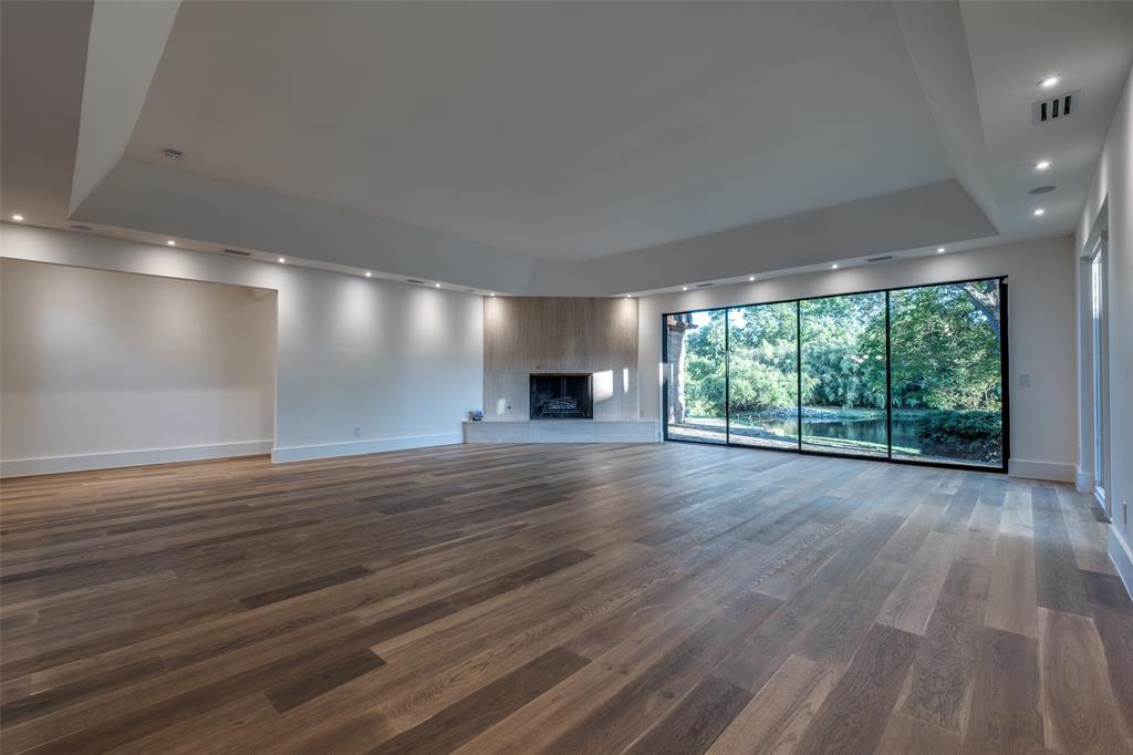 12002 Timberlake Court Dallas, TX 75230 - Photo 13 of 28 an empty room with wooden floor and windows