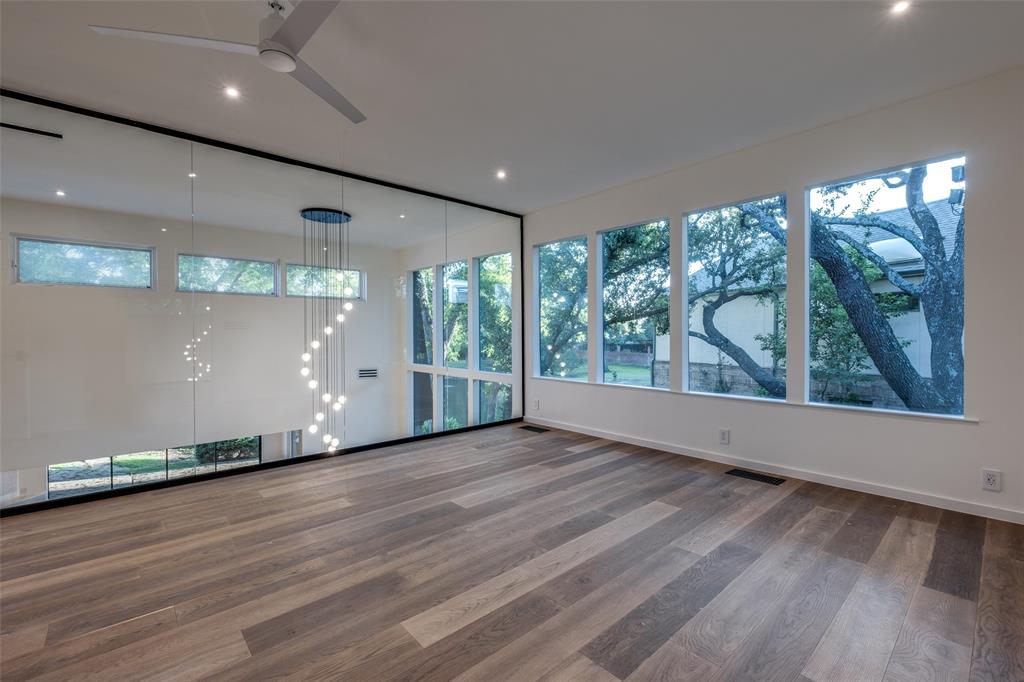 12002 Timberlake Court Dallas, TX 75230 - Photo 15 of 28 an empty room with wooden floor and windows