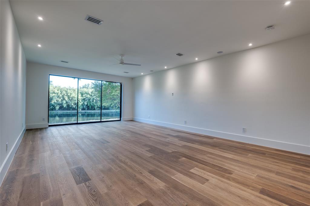 12002 Timberlake Court Dallas, TX 75230 - Photo 16 of 28 an empty room with wooden floor and windows