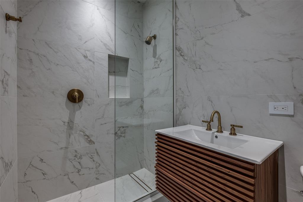 12002 Timberlake Court Dallas, TX 75230 - Photo 20 of 28 a bathroom with a sink a mirror and shower