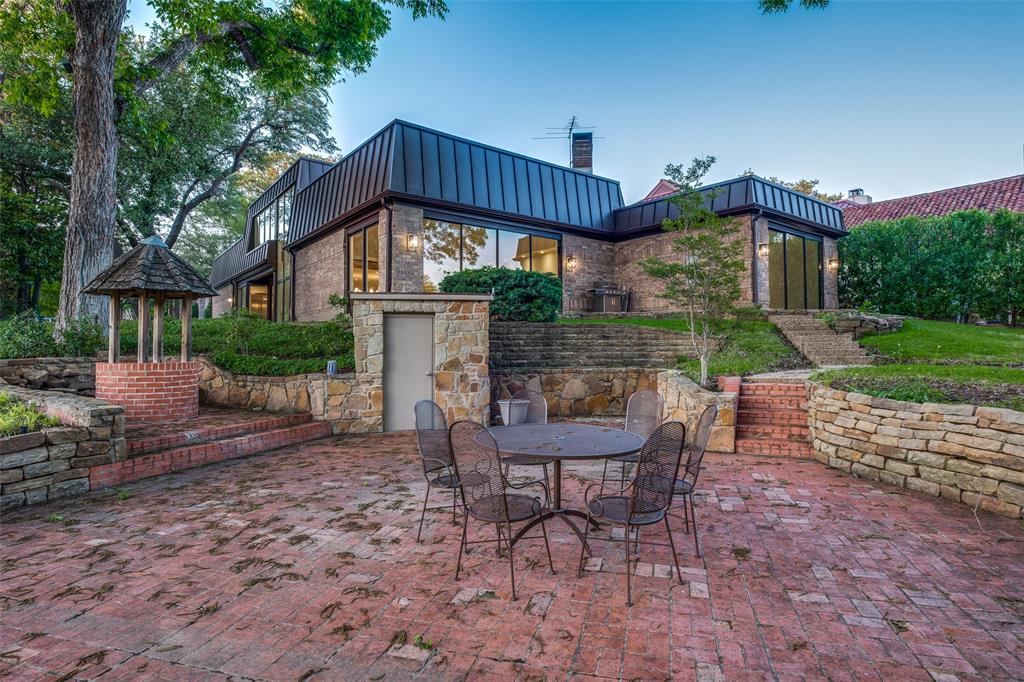 12002 Timberlake Court Dallas, TX 75230 - Photo 2 of 28 a view of a house with a yard chairs and table in patio