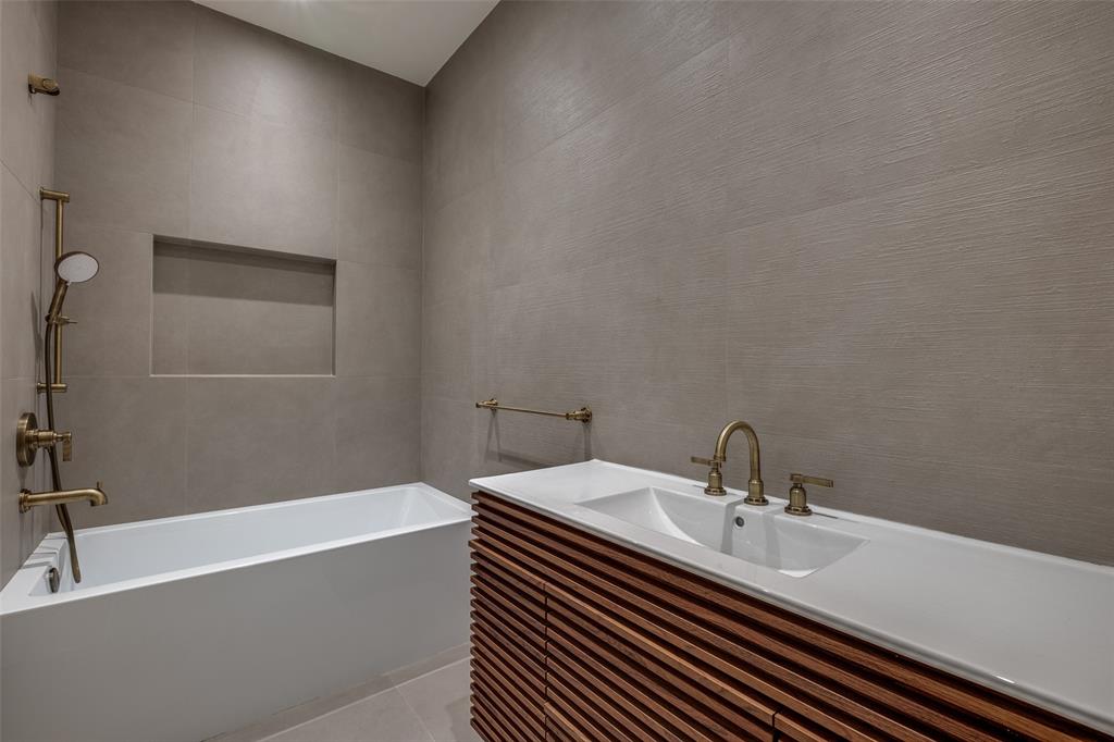 12002 Timberlake Court Dallas, TX 75230 - Photo 21 of 28 a bathroom with a sink and a bathtub