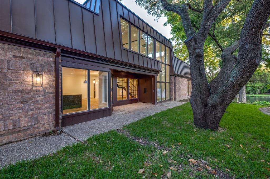 12002 Timberlake Court Dallas, TX 75230 - Photo 22 of 28 a view of a house with a tree and wooden fence