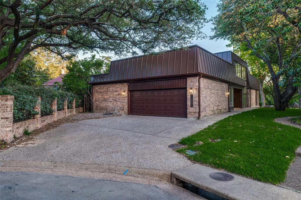 12002 Timberlake Court Dallas, TX 75230 - Photo 23 of 28 a view of a house with a yard and garage