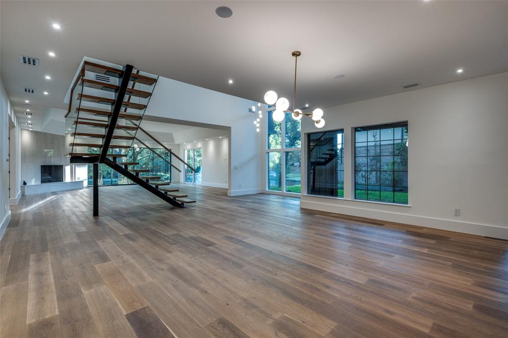 12002 Timberlake Court Dallas, TX 75230 - Photo 4 of 28 a view of a room with wooden floor chandelier and windows