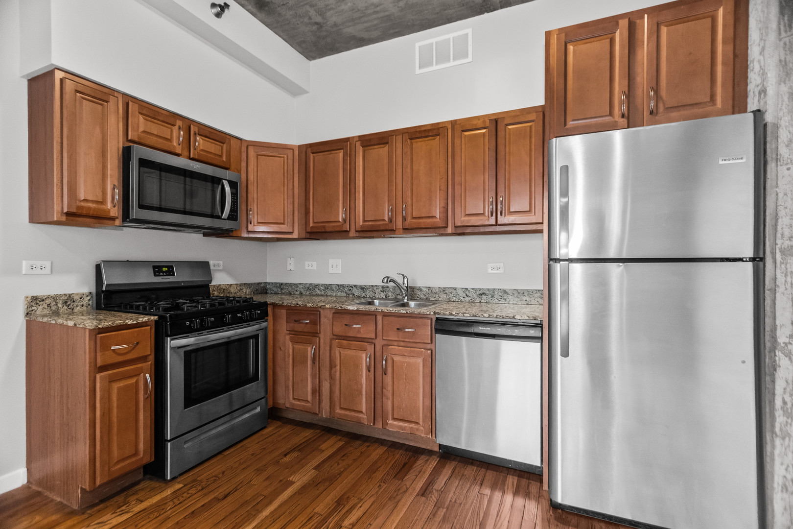 1620 South Michigan Avenue, Unit 324 Chicago, IL 60616 - Photo 11 of 23 a kitchen with stainless steel appliances granite countertop a refrigerator stove a sink and a microwave
