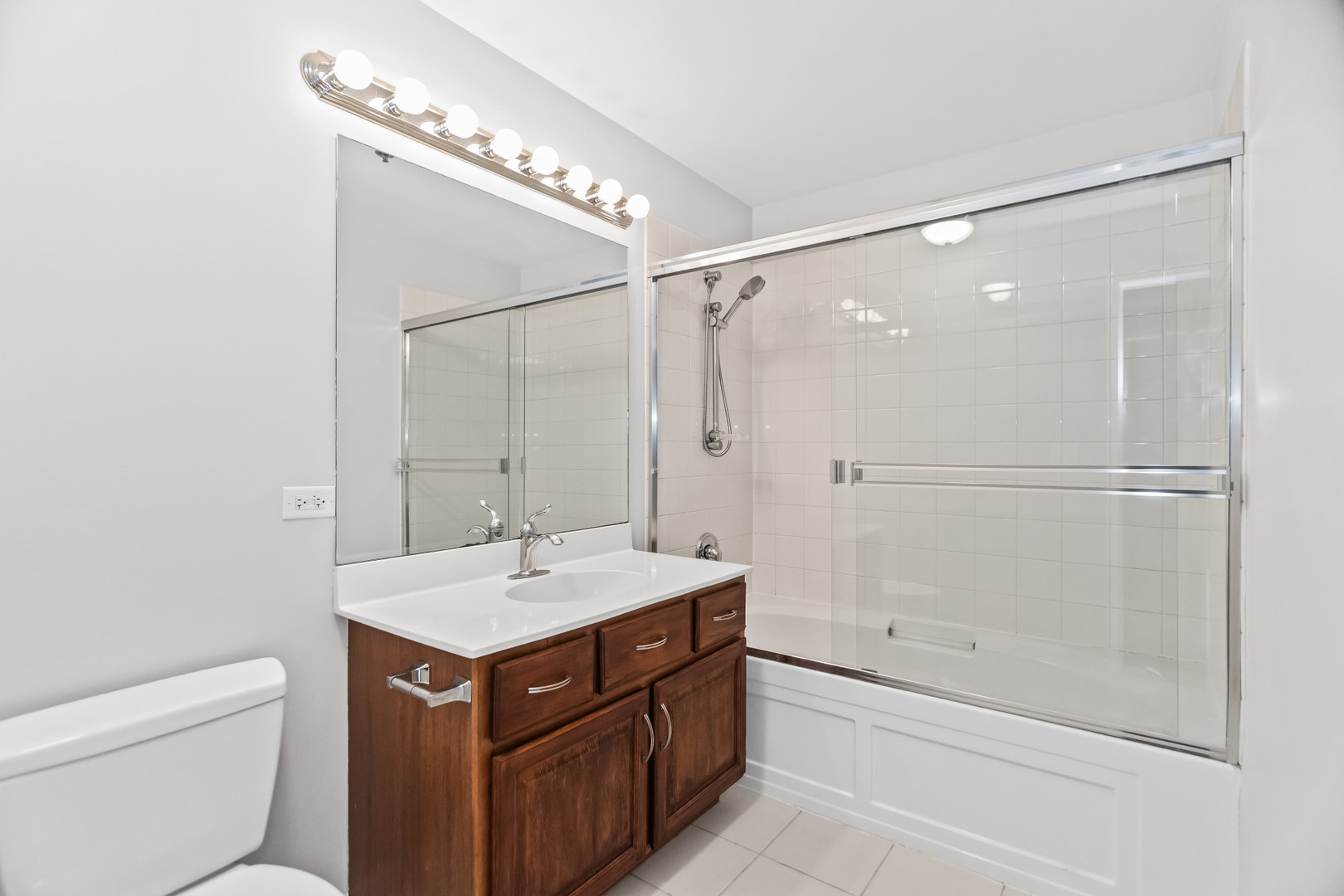 1620 South Michigan Avenue, Unit 324 Chicago, IL 60616 - Photo 20 of 23 a bathroom with a bathtub shower sink vanity and a toilet