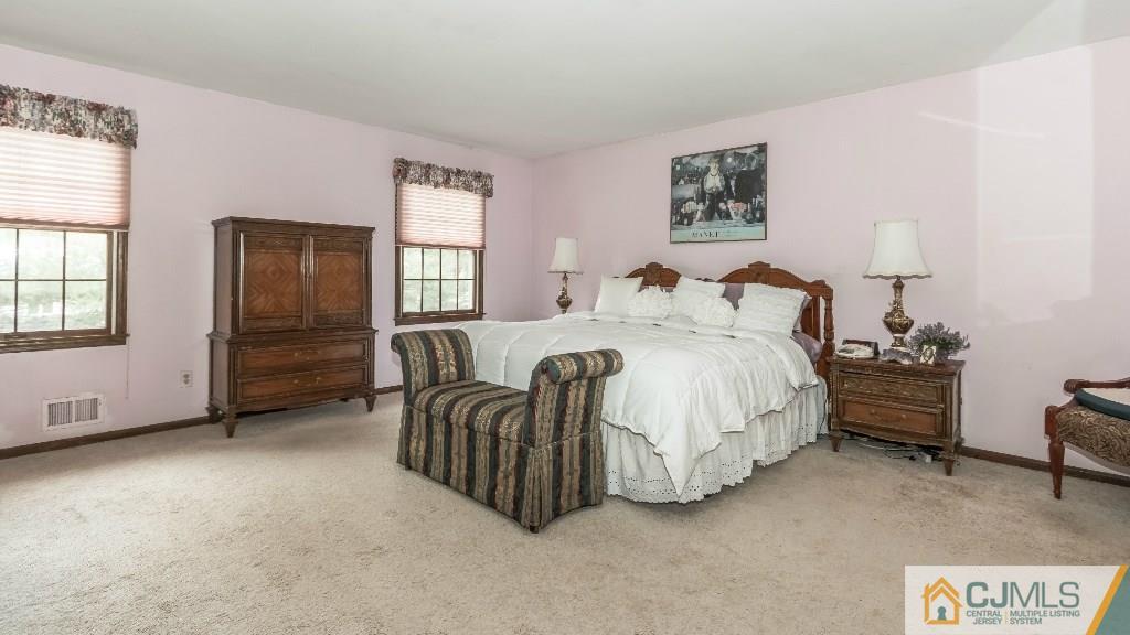 28 Fox Hill Road Edison, NJ 08820 - Photo 12 of 20 a spacious bedroom with a bed and dresser