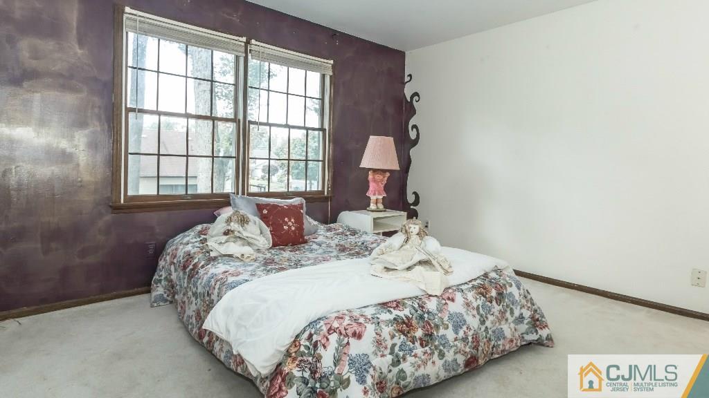 28 Fox Hill Road Edison, NJ 08820 - Photo 15 of 20 a bed sitting in a bedroom next to a window