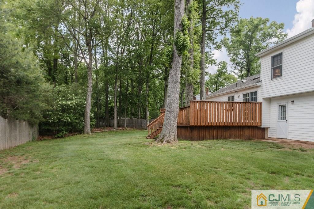 28 Fox Hill Road Edison, NJ 08820 - Photo 19 of 20 a view of a backyard with a small cabin and wooden fence