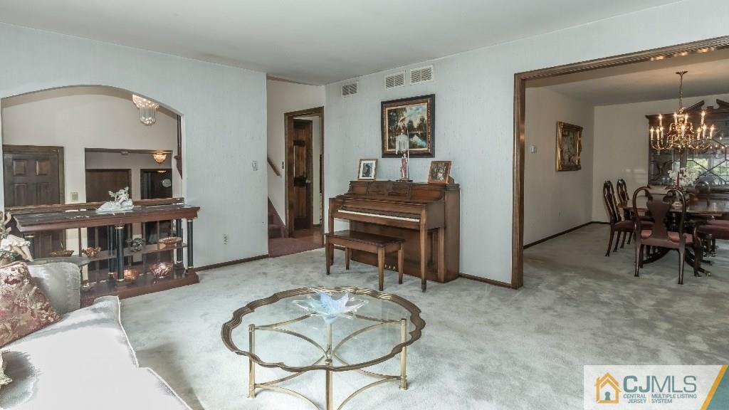 28 Fox Hill Road Edison, NJ 08820 - Photo 7 of 20 a living room with furniture a piano and a fireplace