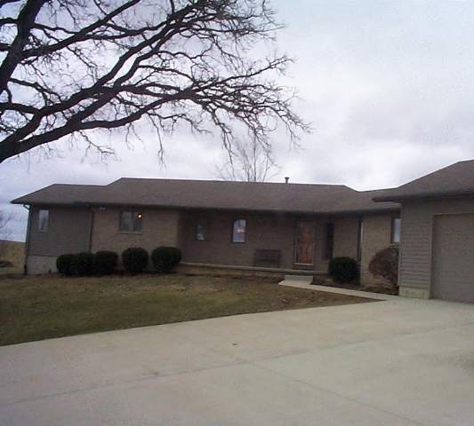 8475 West Mound Road Lena, IL 61048 - Photo 1 of 9 a front view of a house with a yard and garage