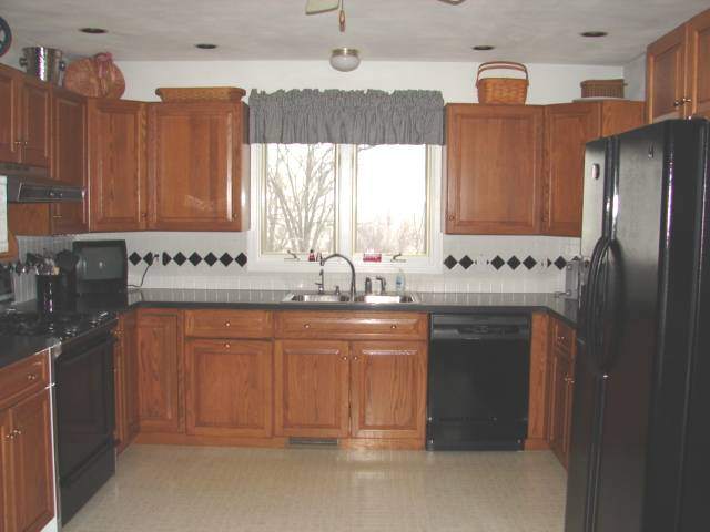 8475 West Mound Road Lena, IL 61048 - Photo 3 of 9 a kitchen with stainless steel appliances granite countertop a sink a stove a refrigerator and cabinets