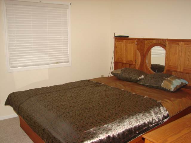 8475 West Mound Road Lena, IL 61048 - Photo 6 of 9 a bed sitting in a bedroom next to a window