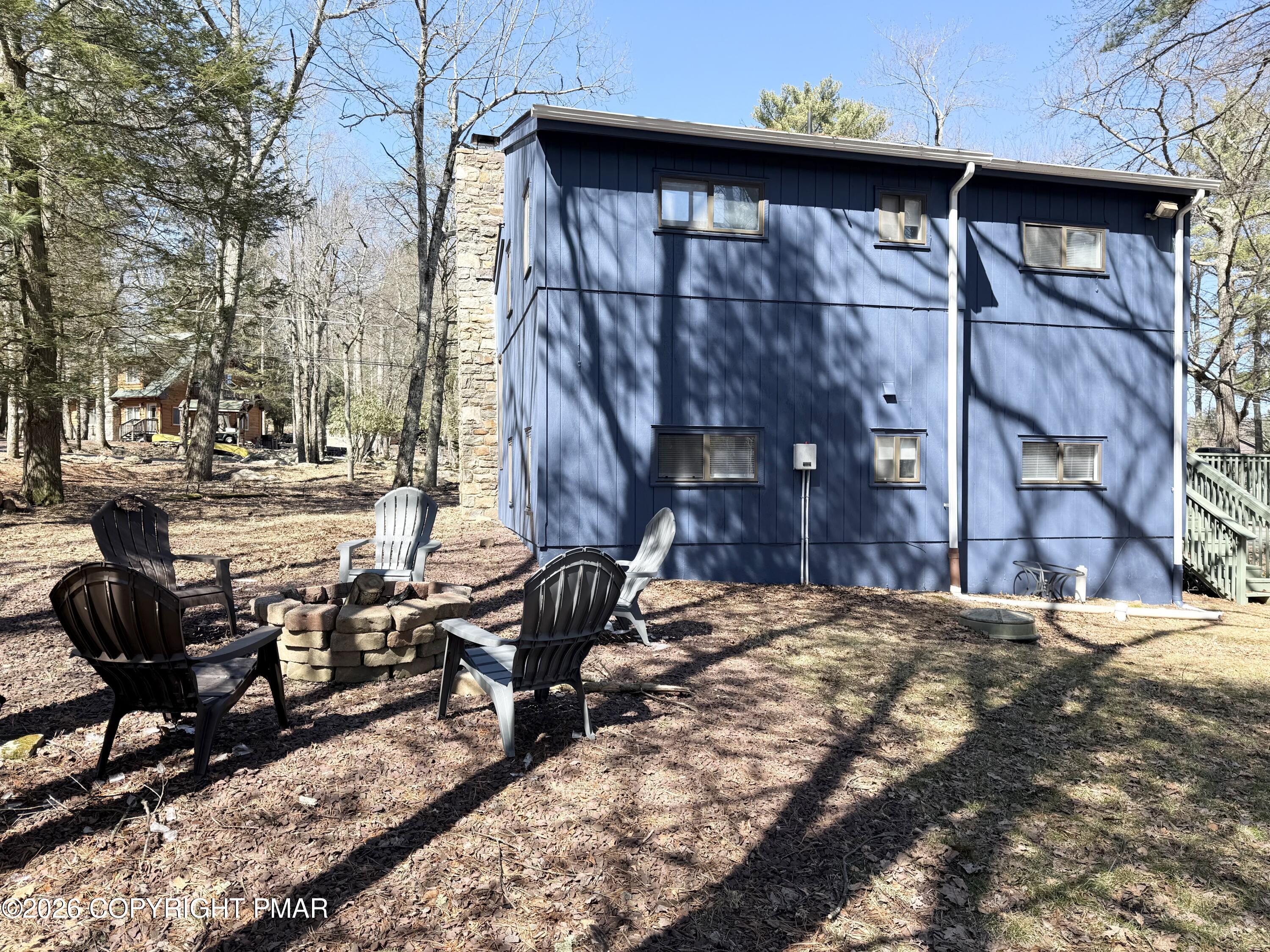 11 Maplewood Road Lake Harmony, PA 18624 - Photo 4 of 44 a view of a chairs and table in backyard