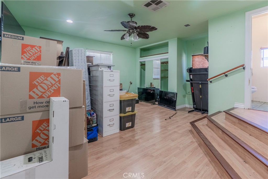 11602 Fellows Avenue Pacoima, CA 91331 - Photo 11 of 40 a bedroom with furniture and a chandelier