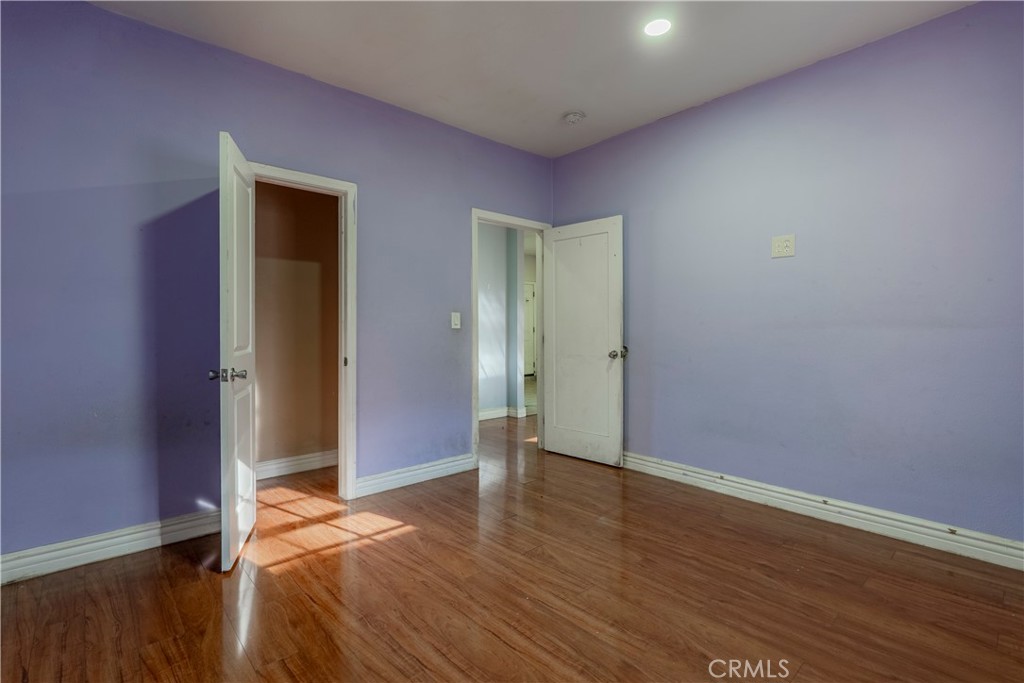 11602 Fellows Avenue Pacoima, CA 91331 - Photo 32 of 40 an empty room with wooden floor and closet