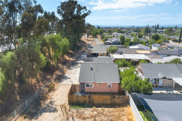 an aerial view of a house with yard swimming pool and lake view