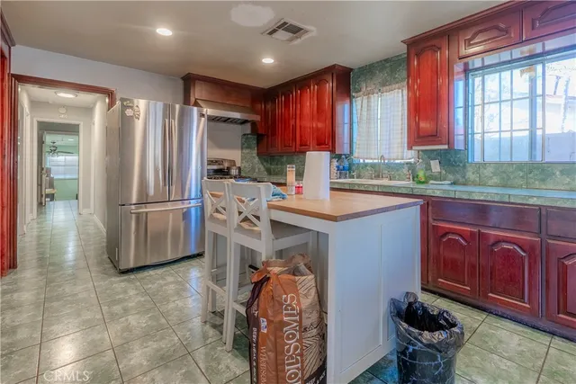 a kitchen with stainless steel appliances granite countertop a refrigerator sink and cabinets