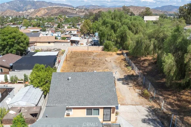 an aerial view of a house with yard