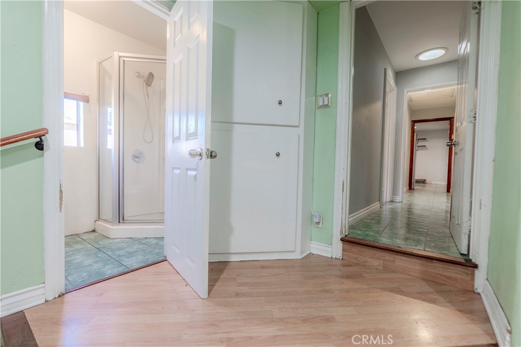 11602 Fellows Avenue Pacoima, CA 91331 - Photo 10 of 40 a view of a hallway with wooden floor and a bathroom