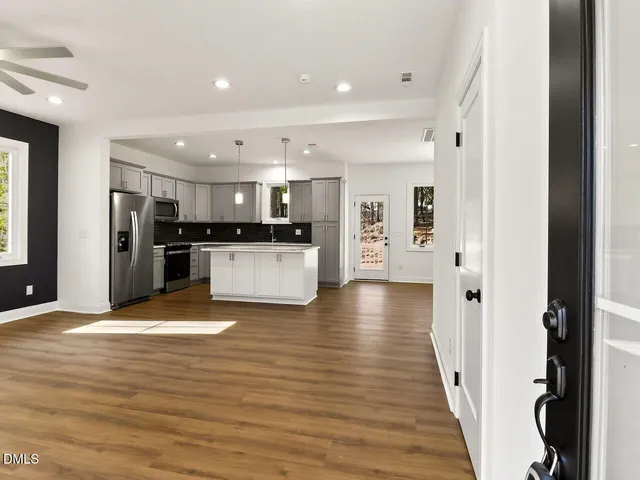 a view of a kitchen with cabinets and stainless steel appliances