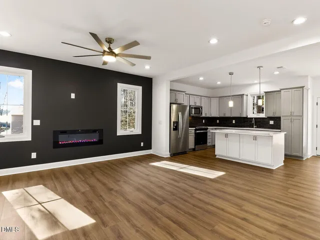 a view of kitchen with refrigerator and window