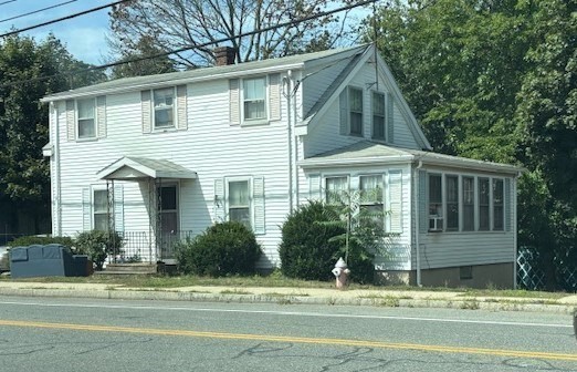24 Lowell Street Wilmington, MA 01887 - Photo 1 of 26 a front view of a house with a garden