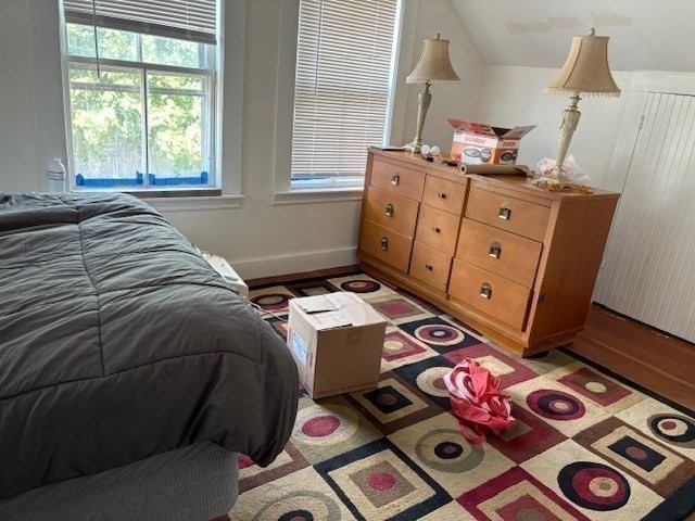 24 Lowell Street Wilmington, MA 01887 - Photo 15 of 26 a bedroom with a bed next to a window