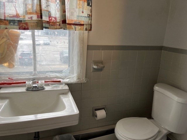 24 Lowell Street Wilmington, MA 01887 - Photo 17 of 26 a bathroom with a sink and a toilet