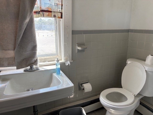 24 Lowell Street Wilmington, MA 01887 - Photo 18 of 26 a bathroom with a toilet and a sink