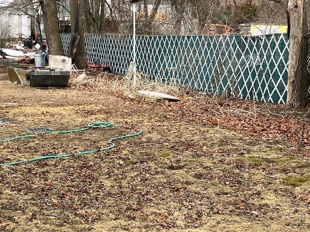 24 Lowell Street Wilmington, MA 01887 - Photo 26 of 26 a view of a backyard with wooden fence