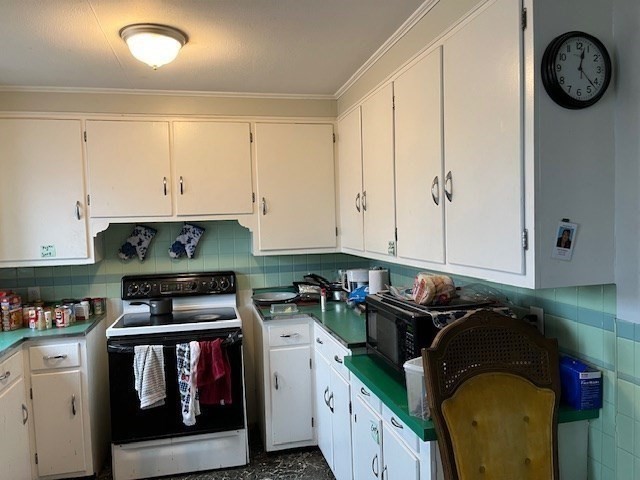 24 Lowell Street Wilmington, MA 01887 - Photo 4 of 26 a kitchen with a stove and cabinets